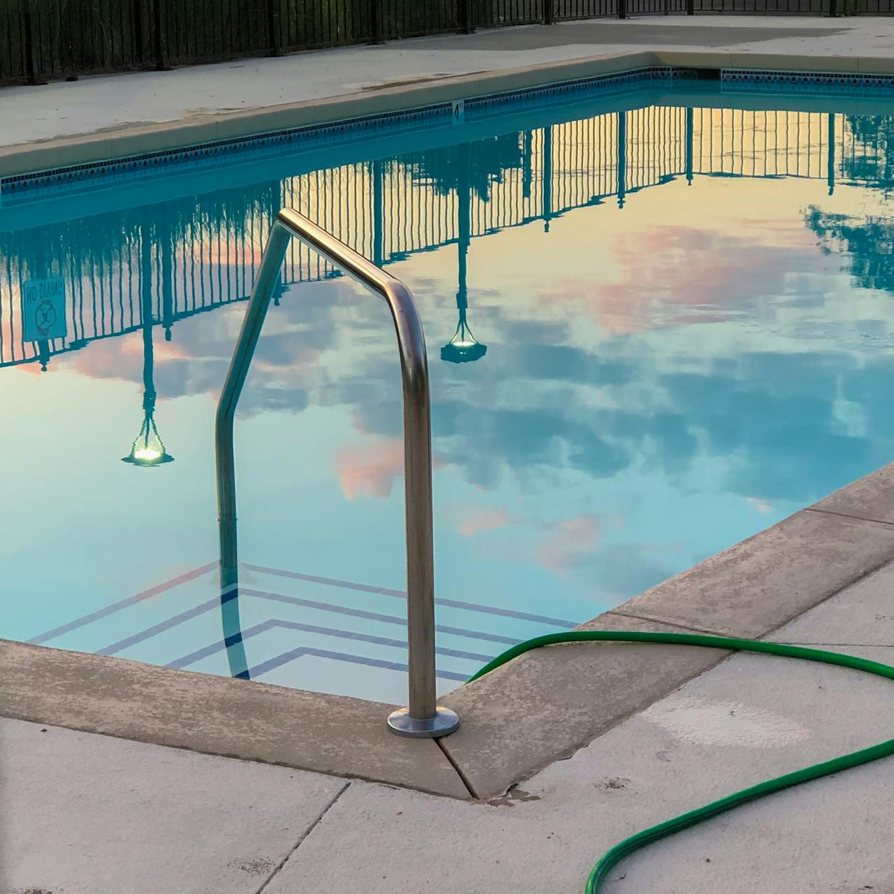 A backyard swimming pool at dusk in the Southlake, Texas area